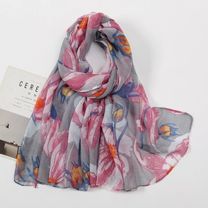 Detailed texture of lightweight voile scarf with pink and orange floral prints