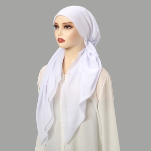 Detail of white semi-transparent chiffon ethnic turban with light draping fabric