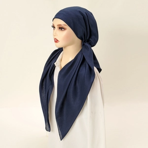 Navy blue ethnic style headscarf with two tails on a minimalist display mannequin