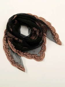 Detailed embroidery on a black lace hijab scarf with copper floral lace edges