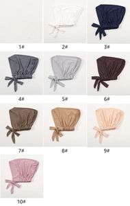 Detail of multi-color modal stretch turbans featuring elastic bands and tie-back closure