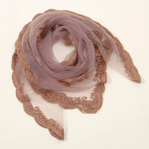 Detail of elegant pink chiffon scarf with intricate dark brown lace embroidery trim