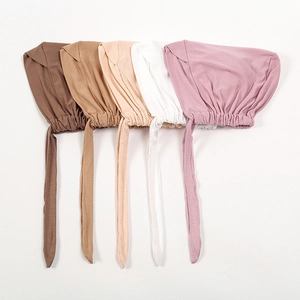 Flat lay of five modal elastic turbans in various colors with adjustable tie-back ribbons