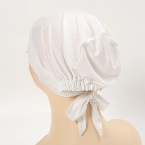 Detail of white modal cotton stretch turban with elastic ruched back and adjustable bow tie