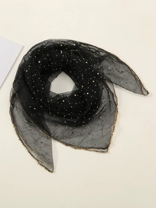 Detail of black mesh headscarf featuring multi-color rhinestones and gold wavy edges