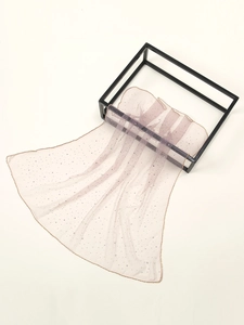 Detail of light pink rhinestone headscarf with gold edging on a modern display rack