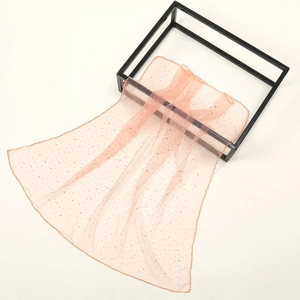 Elegant peach sheer mesh scarf with sparkling rhinestones on a metal display stand