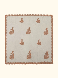 Detail of beige lace scarf with intricate copper paisley embroidery and scalloped edges