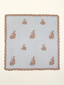 Detailed embroidery on light blue fabric with brown paisley patterns and wavy lace edges