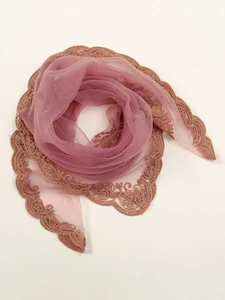 Detailed view of mauve hijab wrap featuring golden brown floral embroidery lace borders