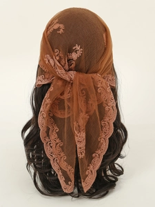 Detail of brown lace hijab with floral embroidery and scalloped edges on mesh fabric
