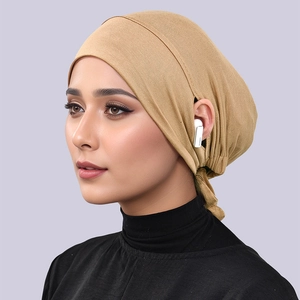 Detail view of khaki modal hijab cap with functional ear holes for earbuds