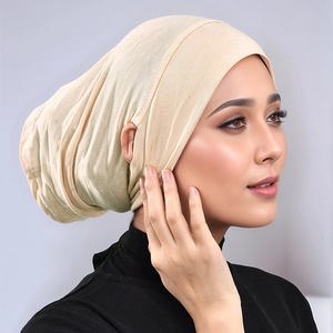 Detail view of beige modal inner hijab cap featuring side ear openings for glasses