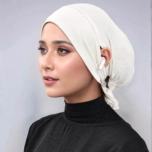 Detail of modal hijab undercap with side ear openings for headphones in cream white