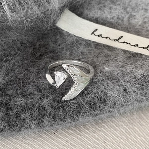 Elegant fishtail open ring with teardrop zircon and silver finish on soft fabric