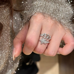 Elegant star-shaped sparkling zircon open ring shown on a model with knit sleeve