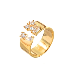 Elegant gold wide open ring featuring inlaid cubic zirconia gems on white background