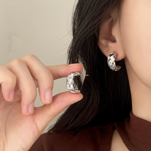 Silver woven C-shaped stud earrings featuring a minimalist braided texture for women