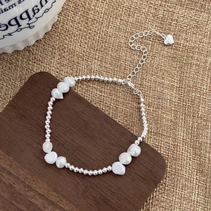 Elegant silver beaded bracelet with irregular white pearls and heart pendant extension chain