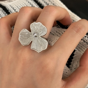 Exaggerated silver flower open ring with textured petals and center zircon stone