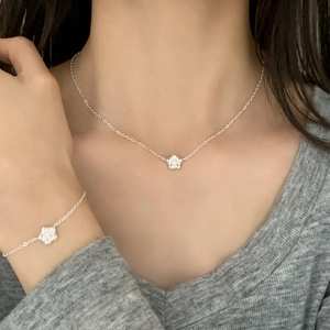 Elegant S925 sterling silver floral necklace and bracelet set worn on neck and wrist