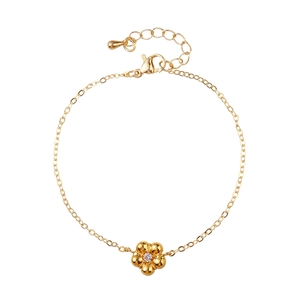 Detail of gold flower pendant with sparkling rhinestone and adjustable chain link