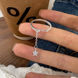 Minimalist silver ring with sparkling zircon star charm on fine chain, lifestyle view