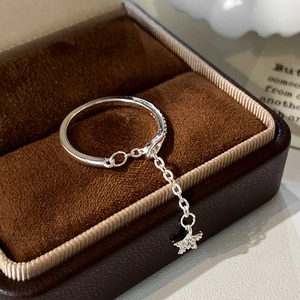 Macro shot of silver star pendant ring with zircon inlay in a velvet jewelry box