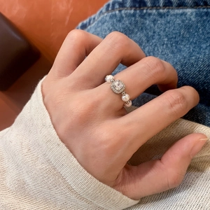 Elegant pearl and zircon square stone ring with a French vintage style worn by a model