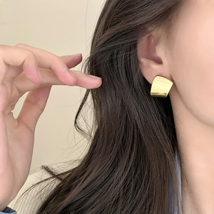 Irregular geometric gold ear studs with a modern minimalist metallic finish for women