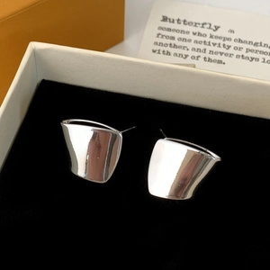 Modern minimalist silver stud earrings with wide curved glossy surface in a velvet gift box