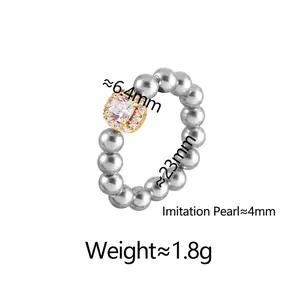 Elegant gold open ring with grey pearls and square zircon centerpiece on white background