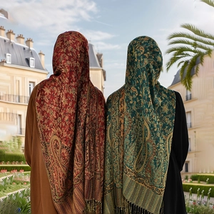 Close-up of elegant paisley pattern and delicate fringe tassels on ethnic pashmina shawl