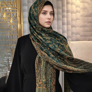 Ethnic paisley print shawl in deep green with gold floral patterns and fringe