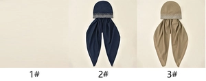 Close-up of navy and khaki hijabs with silver sequin stripes on elastic fabric