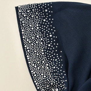 Detailed view of dark blue headscarf with shimmering silver rhinestones along the edge
