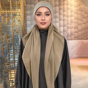 Detailed close-up of a khaki Muslim hijab with sparkling rhinestones on the headband