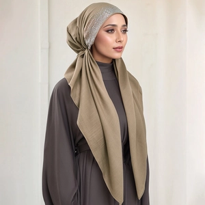 Close-up of elegant taupe hijab featuring intricate silver rhinestone detailing on forehead