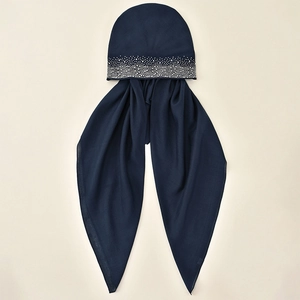 Close-up of sparkling rhinestones on navy blue stretch hijab turban and headscarf fabric