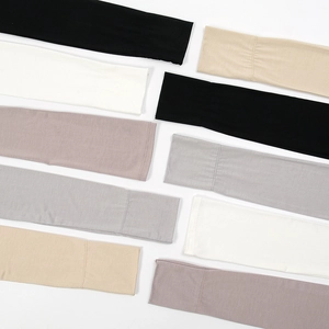 Detailed flat lay of modal sun protection arm sleeves in black white and neutral colors