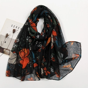 Macro view of floral print voile scarf with vintage flowers on a black background