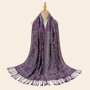 Detailed embroidery of purple paisley shawl with elegant handmade long fringe tassels