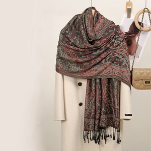 Ethnic paisley embroidered shawl with fringe tassels on wool coat with a chain bag