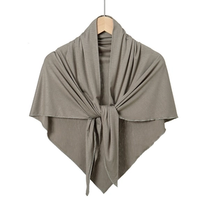 Close-up of soft mercerized cotton triangle shawl with delicate knit texture in grey