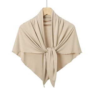 Detail of mercerized cotton triangle scarf showing soft beige knit texture and front knot