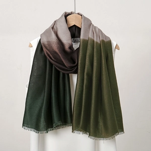 Detailed texture of gradient linen scarf with short fringe edges in grey and green