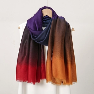 Close-up of gradient cotton-linen scarf with colorful fringe and soft texture