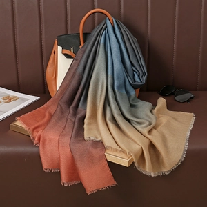 Colorful gradient pashmina shawl with fringe edges displayed on luxury background