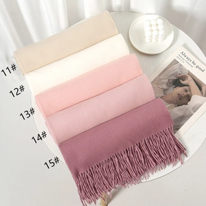 Stack of thick solid cashmere-like scarves with fringe in five Morandi tones