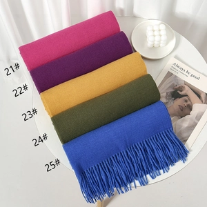 Row of colorful scarves with tassels in rose, purple, yellow, green and royal blue